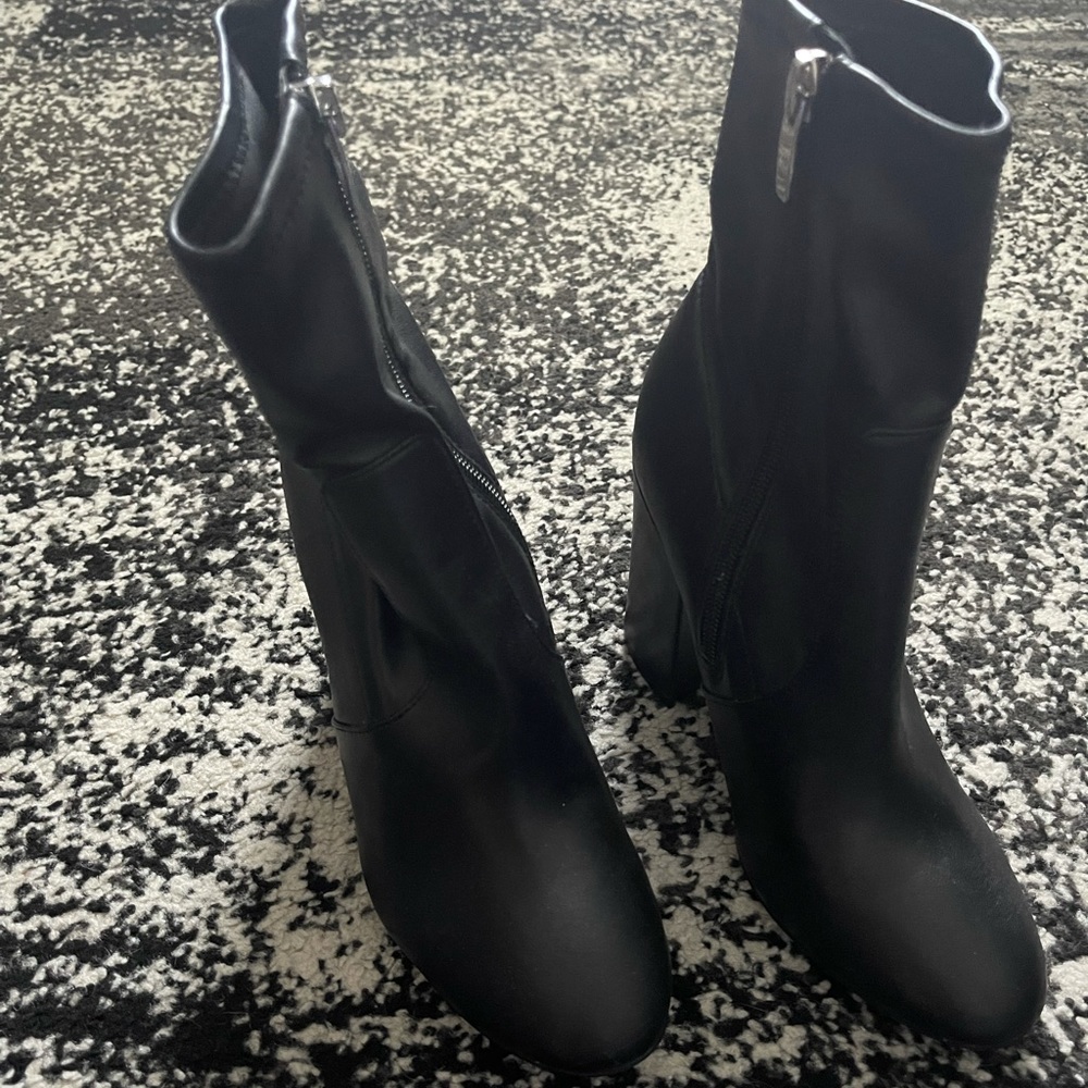 Black heeled leather boots.